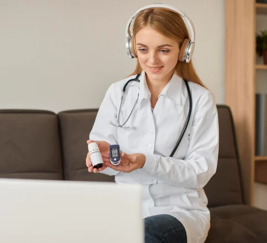 front-view-smiley-covid-recovery-center-female-doctor-with-headphones-holding-oximeter
